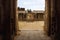 View of the maha-mandapa from the North Gopura of the inner courtyard, an entrance to the Achyuta Raya temple, Hampi, Karnataka