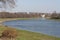 View on the main bridge across the river Uzh in Uzhhorod in warm sun light. High green tree growing nearby, its branches hanging o