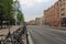 View of main downtown street in Uppsala, Sweden, Europe. Parking lot for bicycles near a busstop, green trees.