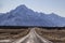 View of the majestic Aoraki Mount Cook with the road leading to Mount Cook Village in winter