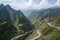 view of majestic mountain range, with a single road winding through it