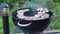 View of male grilling meat steak and onion outdoors on summer day.