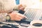 View of male hands holding credit card numbers typed on the computer keyboard while sitting at a desk - focus hand