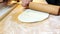 View of male hands rolling dough, preparing Christmas cookies