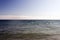 A view of Malibu beach and a bird stork flying over the ocean in California