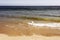 A view of Malibu beach and a bird stork flying over the ocean in California