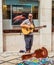 View of Man busker playing guitar on the street of Coimbra, Portugal