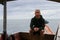 view of a man enjoying on the sailing traditional boat heading to Rangko Cave West Manggarai East Nusa Tenggara