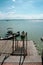 View of a man by the jetty securing rope from his boat to a wooden jetty. view from a wooden jetty