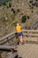 View of a man looking landscape on belvedere, wooden suspended pedestrian walkway on mountains, overlooking the Paiva river