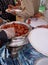 View  of Man serving Indian sweet desert Gulab jamun to people