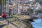 View of man sitting on the stairs at the docks, looking at the river Douro, Gaia city on background