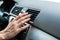 View of man touching air conditioner switch in car