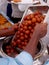 View  of Man transferring Indian sweet desert Gulab jamun inn to serving bowl