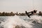 view of man on wakeboard making flip over splashing river