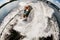 View of man wakesurfer who rides along wave on board