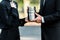 View of man and woman holding mortuary urn in graveyard