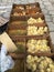 A view of many newborn yellow and brown chicken chicks that are for sale in cartonnen boxes