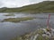 View of marked shallow ford for hikers to crossing mountain river at Duottar lake at Padjelantaleden hiking trail in