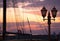 View of the mast of a ship with gear and street light.