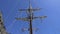 View of the mast of yacht sailing among mountain cliffs