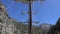 View of the mast of yacht sailing among mountain cliffs