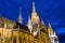 View of the Matthias Church during blue hour, roman catholic church located in Budapest, Hungary inside Fisherman`s Bastion at the