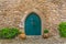 View of the medieval gate door on Luso Roman castle of Ã“bidos, with ceramic pot with plants, in Portugal