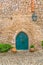 View of the medieval gate door on Luso Roman castle of Ã“bidos, with ceramic pot with plants, in Portugal