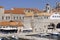 View of the medieval Old Port by Adriatic Sea with moored ships and City Walls, Dubrovnik, Croatia