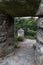 View of the medieval stone tower through the loophole in the stone wall.