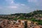 View of the medieval Verona, Italy. Tiled roofs of houses. In the background Santuario della Madonna di Lourdes