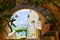 View of a Mediterranean bay from a stone arch of a medieval village in the Ligurian Riviera, Borgio Verezzi, Liguria, Italy