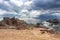 View of Mediterranean sea and beautiful light through heavy blue clouds, Lloret de Mar, Spain