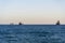 View of the Mediterranean sea with three ships on the horizon from a seaside pathway of Limassol