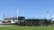 View of the Melbourne Cricket Ground with green grass and blue sky background on a sunny day