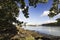 View of the Menai Suspension Bridge in the distance from the banks of the Menai Strait