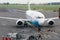 View of Merpati Airlines low cost carrier airliner on apron with ground crew at Juanda International Airport.