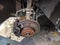View of metallic car disk where tire stands and other car mechanical machinery in a car mechanics and repair store, waiting for