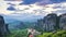 View of Meteora valley at daytime, with beautiful clouds, over Rousanou nunnery and St Nicholas Anapausas monastery, Kastraki, Kal