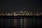 View of metro San Diego from Shelter Island at night with reflection of lights in the water