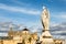 View of Mezquita, Catedral de Cordoba behind an angel statue on the roman bridge