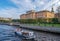 View of the Mikhailovsky Castle and the Moika River with a passing excursion pleasure boat