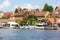 View from MikoÅ‚ajskie Lake of town, marina for yachts and boats at the waterfront, Mikolajki, Masuria, Poland