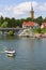 View from MikoÅ‚ajskie Lake of town, marina for yachts and boats at the waterfront, Mikolajki, Masuria, Poland