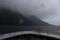 View of Milford Sound on a foggy day from a cruise ship deck, New Zealand.