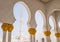 View of Minaret through Horseshoe Arch of Sheikh Zayed Grand Mosque in Abu Dhabi, UAE