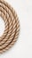 view Minimalist Topviewneatly arranged rope coils on white