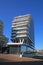 View on modern architcture dpg media building in dutch river harbor against blue sky