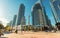 View of a modern high rise residential,office condo buildings with people walking, exploring in background on sunny warm autumn se